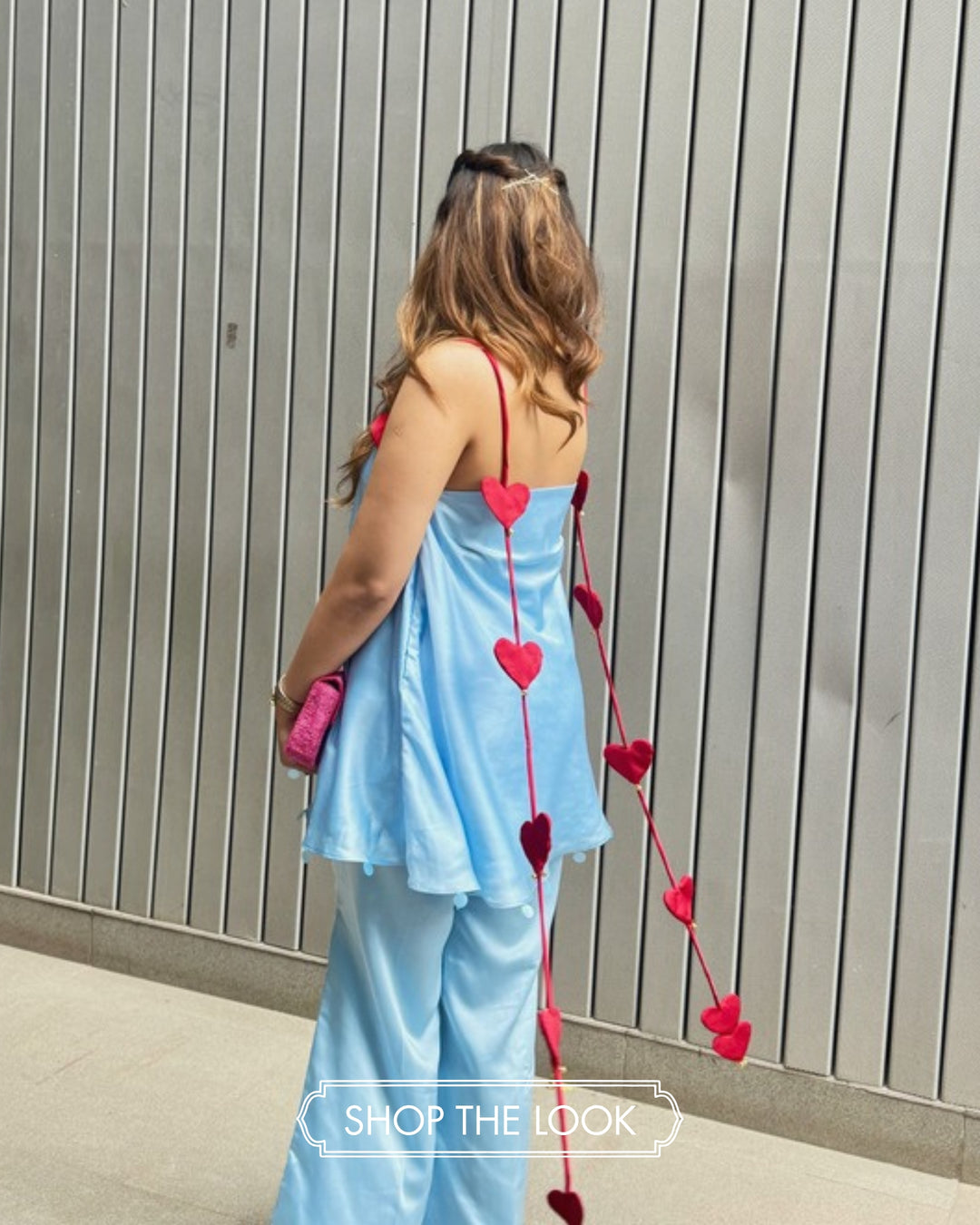 The Sky Dilbar set with red heart ties down the back.